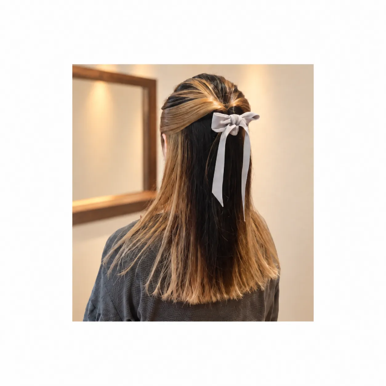 淡いリボンでまとめた、ロングヘアのハーフアップアレンジの後ろ姿